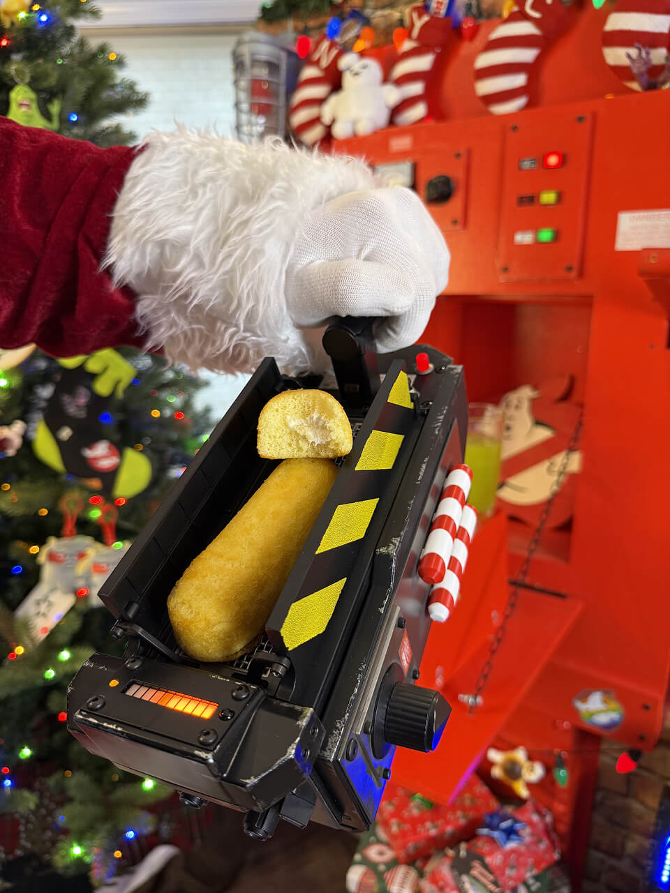 Santa Claus holding a ghost trap with Twinkie inside